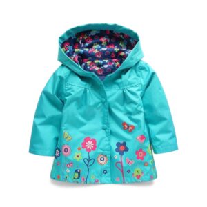 Grüne Regenjas meisjes met capuchon mit Blumenmuster auf dem Stoff und in der Innenfütterung vor weißem Hintergrund.